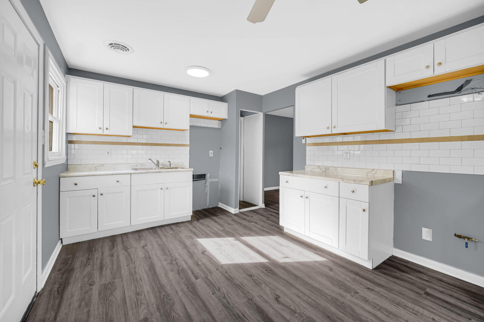 1159 Fayette Street Gary, IN 46403 - Photo 3 of 19 a kitchen with cabinets wooden floor and a sink