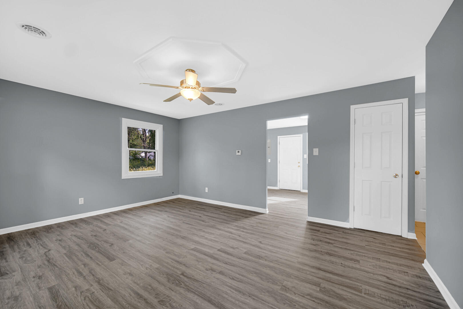 1159 Fayette Street Gary, IN 46403 - Photo 7 of 19 a view of an empty room with a chandelier fan and a window