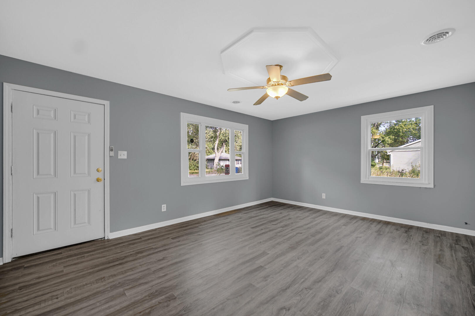 1159 Fayette Street Gary, IN 46403 - Photo 8 of 19 a view of an empty room with a window and wooden floor