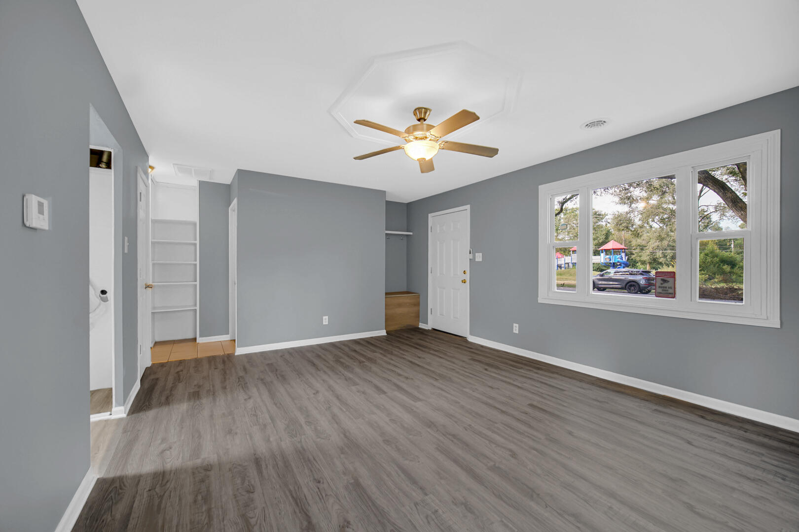 1159 Fayette Street Gary, IN 46403 - Photo 10 of 19 an empty room with wooden floor and windows