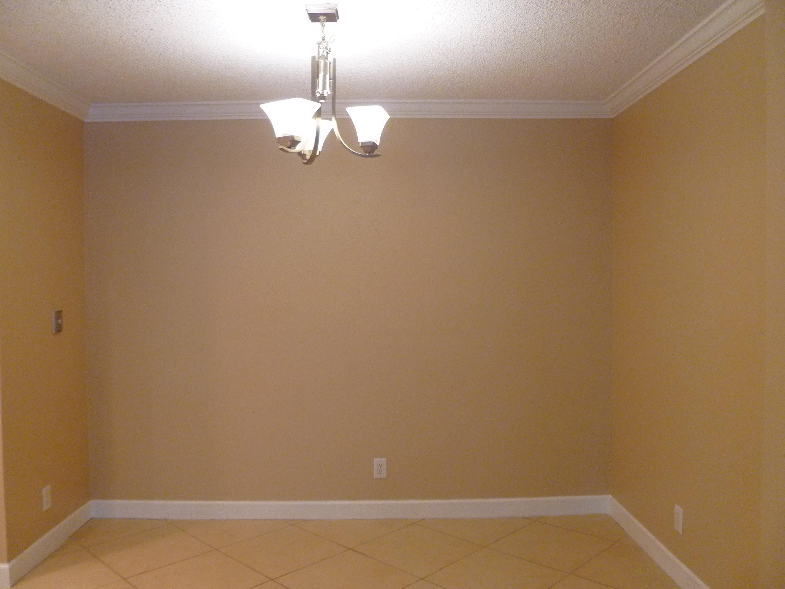 950 Ponce De Leon Road, Unit 104 Boca Raton, FL 33432 - Photo 13 of 33 a view of a room with a hanging light and wood floor