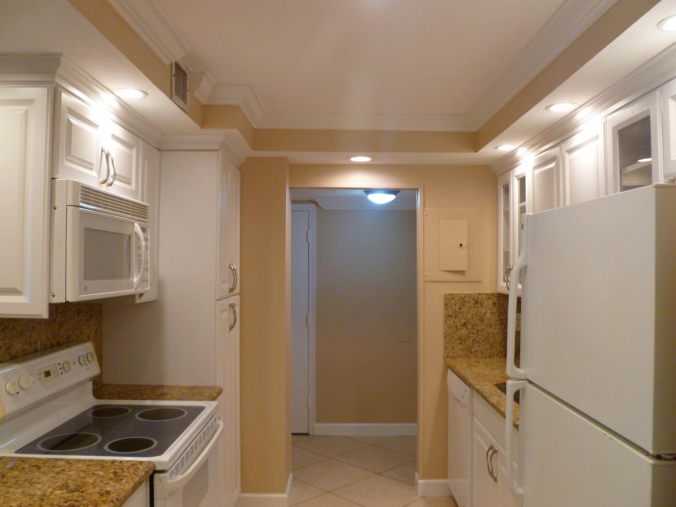 950 Ponce De Leon Road, Unit 104 Boca Raton, FL 33432 - Photo 14 of 33 a kitchen that has a sink a refrigerator and cabinets