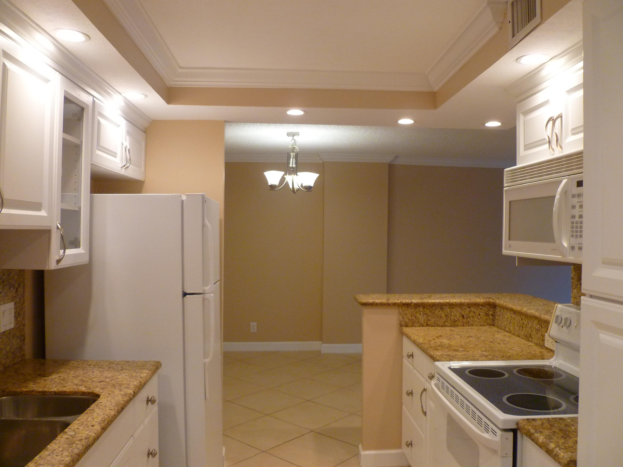 950 Ponce De Leon Road, Unit 104 Boca Raton, FL 33432 - Photo 16 of 33 a kitchen with a sink a refrigerator and a stove