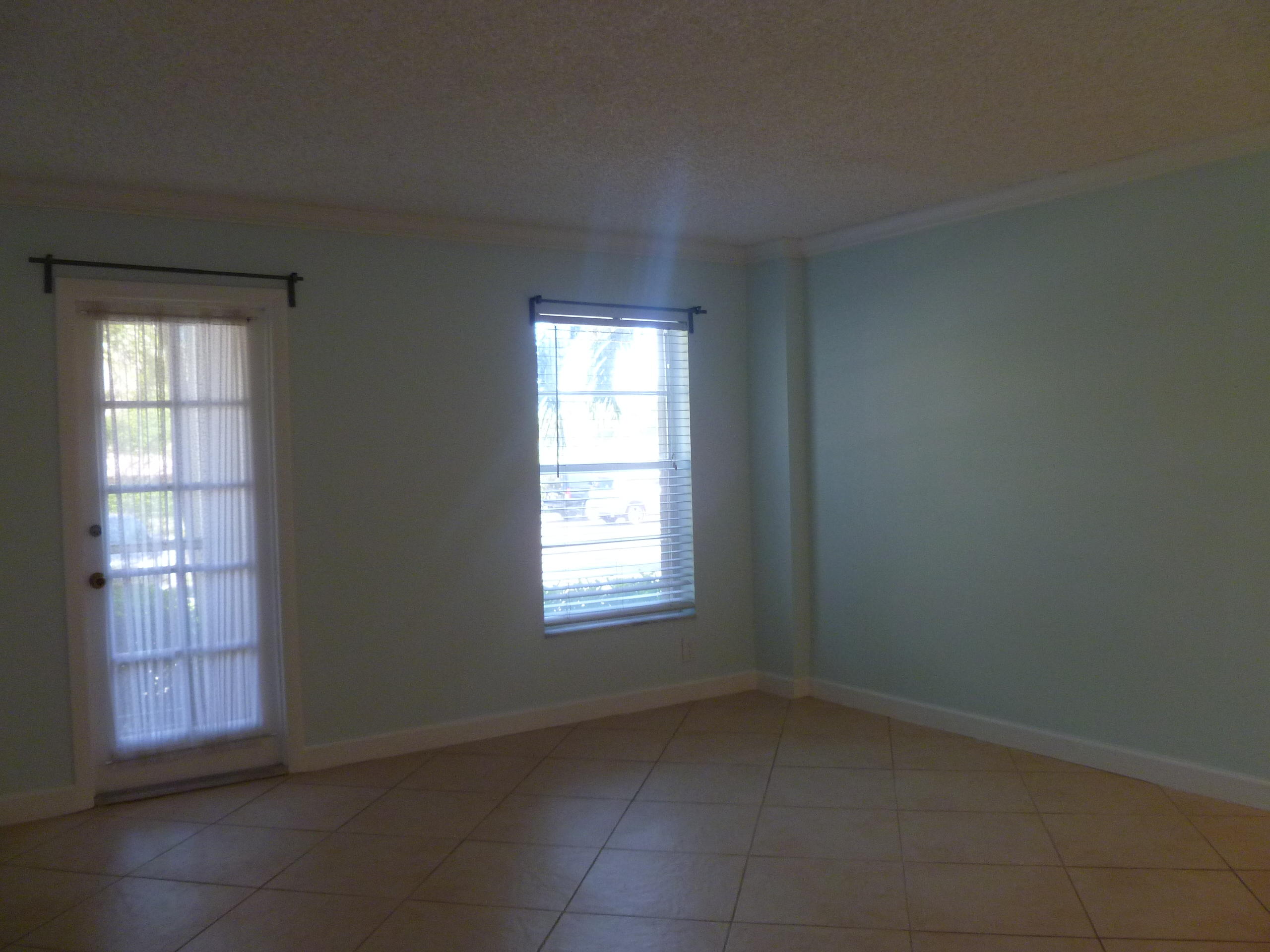 950 Ponce De Leon Road, Unit 104 Boca Raton, FL 33432 - Photo 17 of 33 an empty room with windows