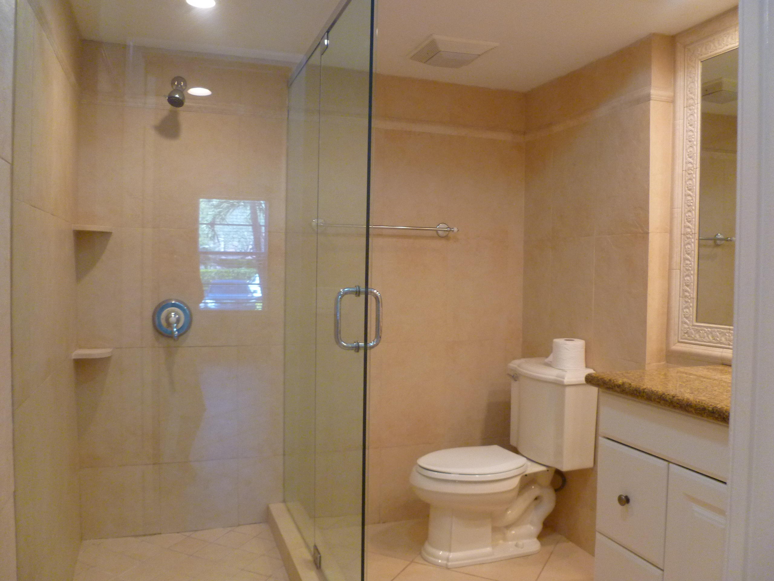 950 Ponce De Leon Road, Unit 104 Boca Raton, FL 33432 - Photo 18 of 33 a bathroom with a toilet and shower