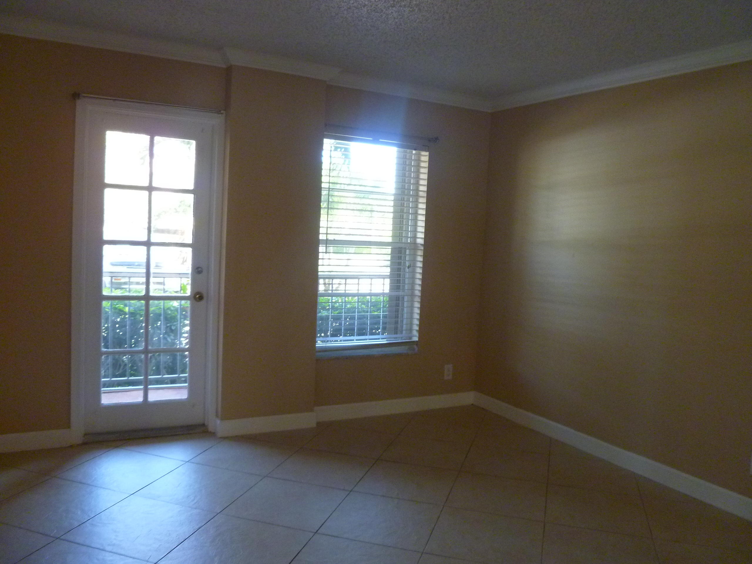 950 Ponce De Leon Road, Unit 104 Boca Raton, FL 33432 - Photo 20 of 33 an empty room with windows