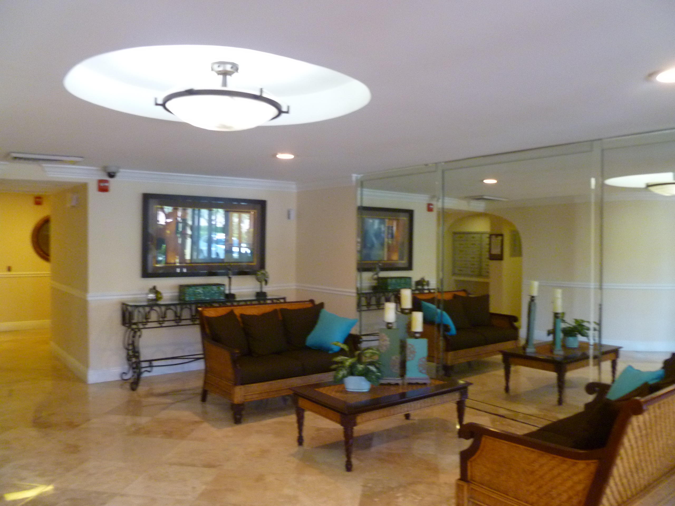950 Ponce De Leon Road, Unit 104 Boca Raton, FL 33432 - Photo 4 of 33 a living room with furniture and a flat screen tv