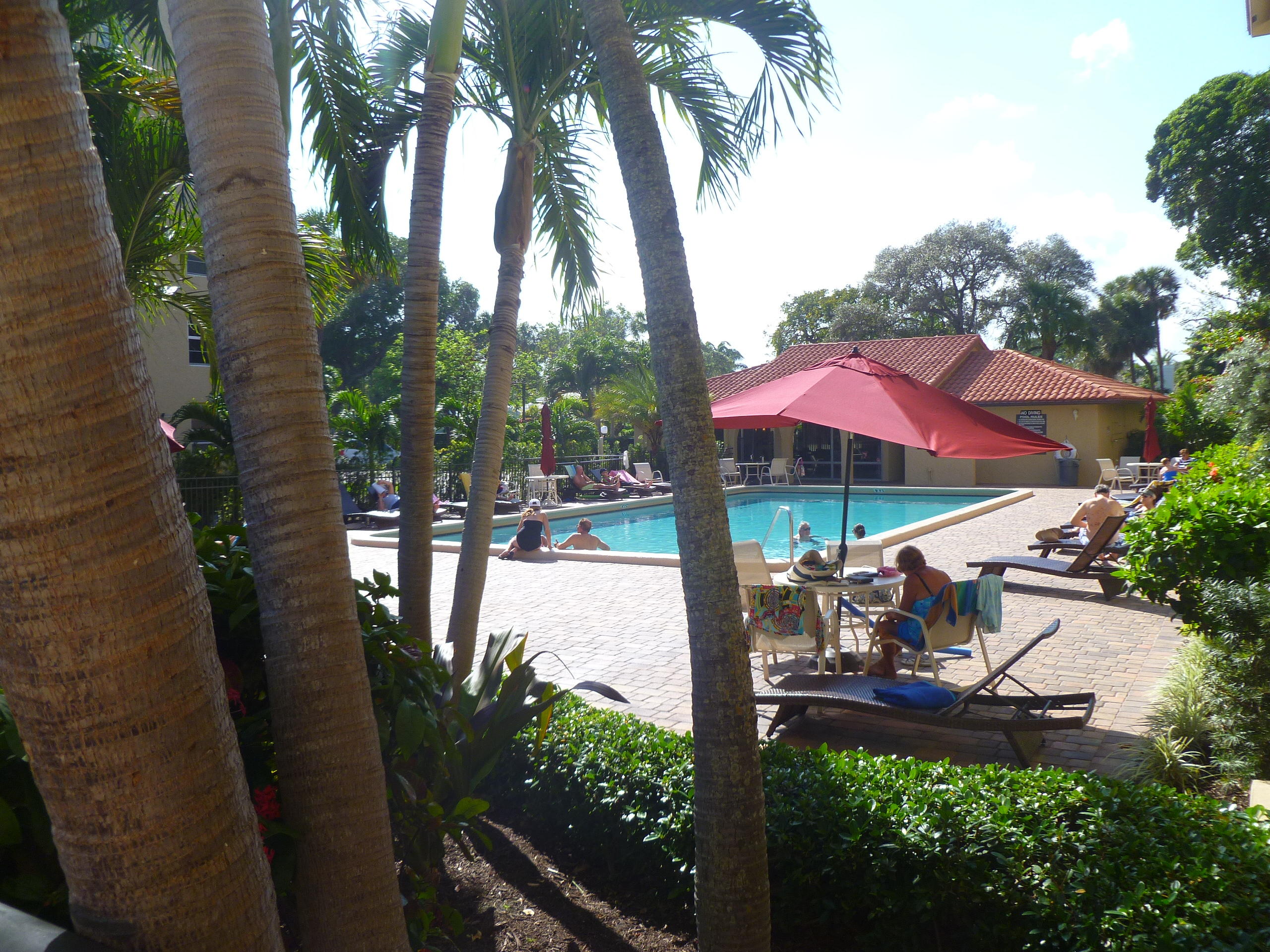 950 Ponce De Leon Road, Unit 104 Boca Raton, FL 33432 - Photo 7 of 33 a view of a patio with chairs and table under an umbrella