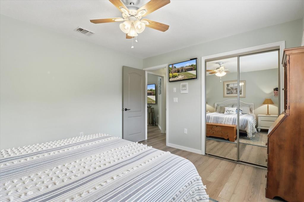 16 Calendula Court Homosassa, FL 34446 - Photo 20 of 50 a bedroom with a bed and wooden floor