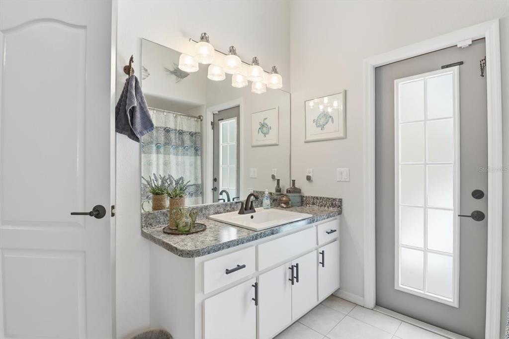 16 Calendula Court Homosassa, FL 34446 - Photo 24 of 50 a bathroom with a granite countertop sink and a mirror