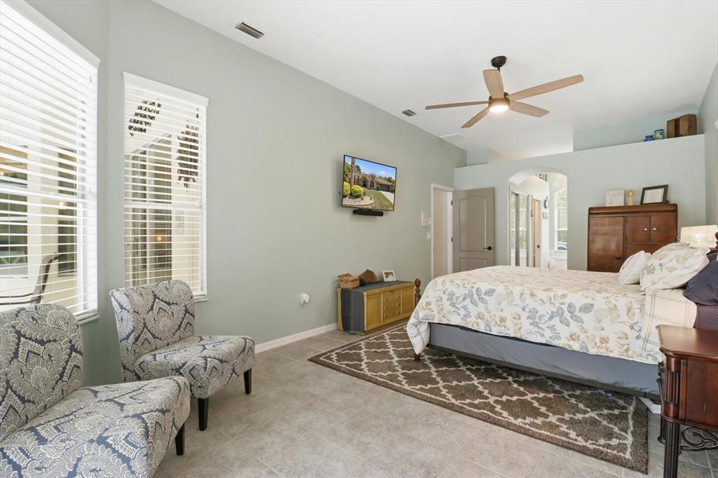 16 Calendula Court Homosassa, FL 34446 - Photo 27 of 50 a bedroom with a bed and ceiling fan