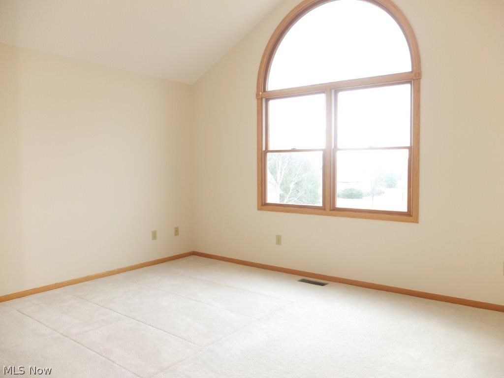 7327 Navarre Road Southwest Massillon, OH 44646 - Photo 10 of 26 Bedroom 2 has vaulted ceilings and a huge arched window.