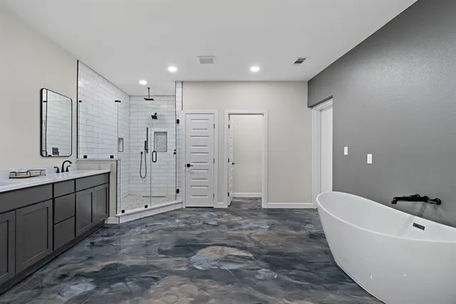 a bathroom with a bathtub and shower