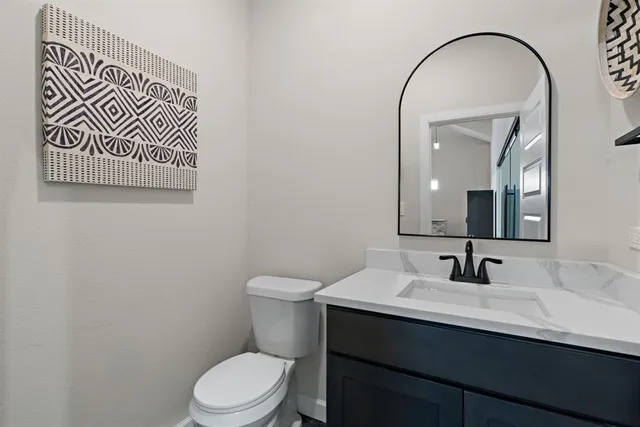 a bathroom with a sink a toilet and mirror