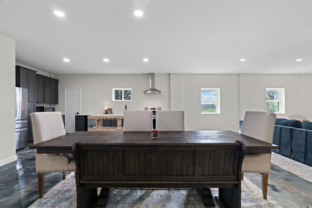 5410 Buffalo Ridge Drive Stephenville, TX 76401 - Photo 10 of 40 a kitchen with a dining table chairs and refrigerator