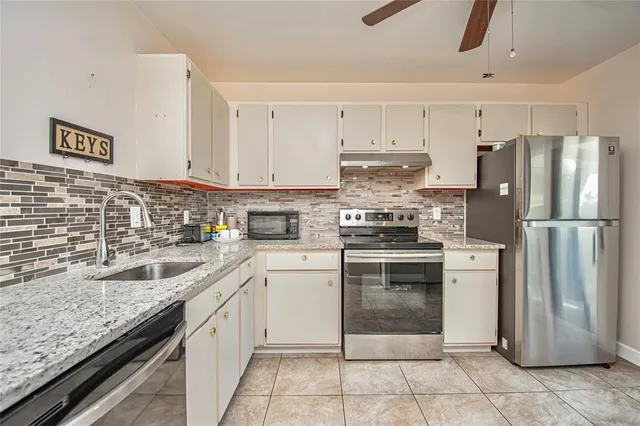 a kitchen with a sink cabinets and stainless steel appliances