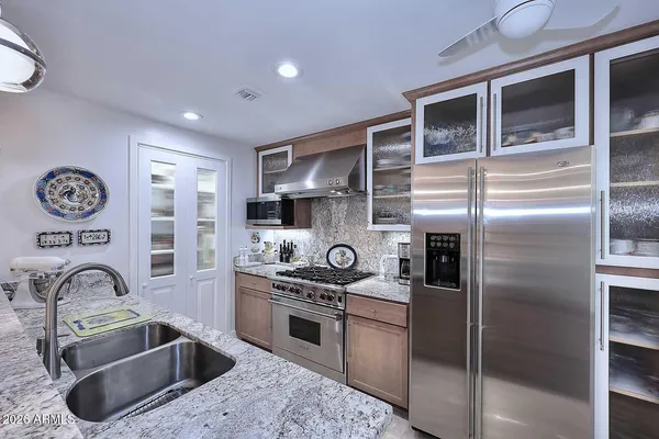 a spacious bathroom with a shower sink and mirror