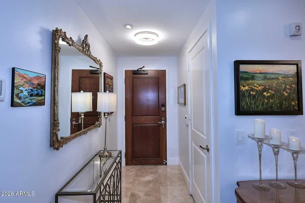 a living room with furniture a flat screen tv and kitchen view