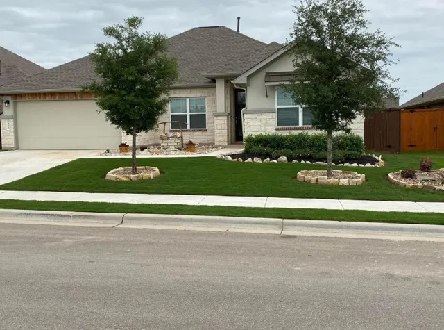 a front view of house with yard and green space