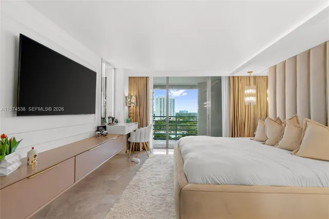 a spacious bedroom with a large bed and a flat screen tv