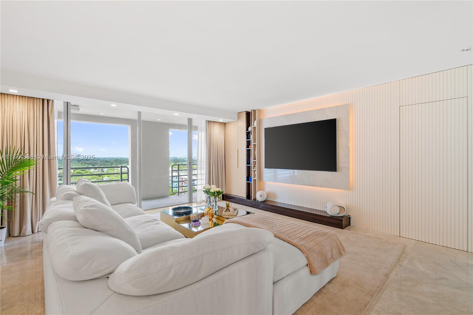 2025 Brickell Avenue, Unit 1705 Miami, FL 33129 - Photo 2 of 50 a living room with furniture floor to ceiling window and a flat screen tv