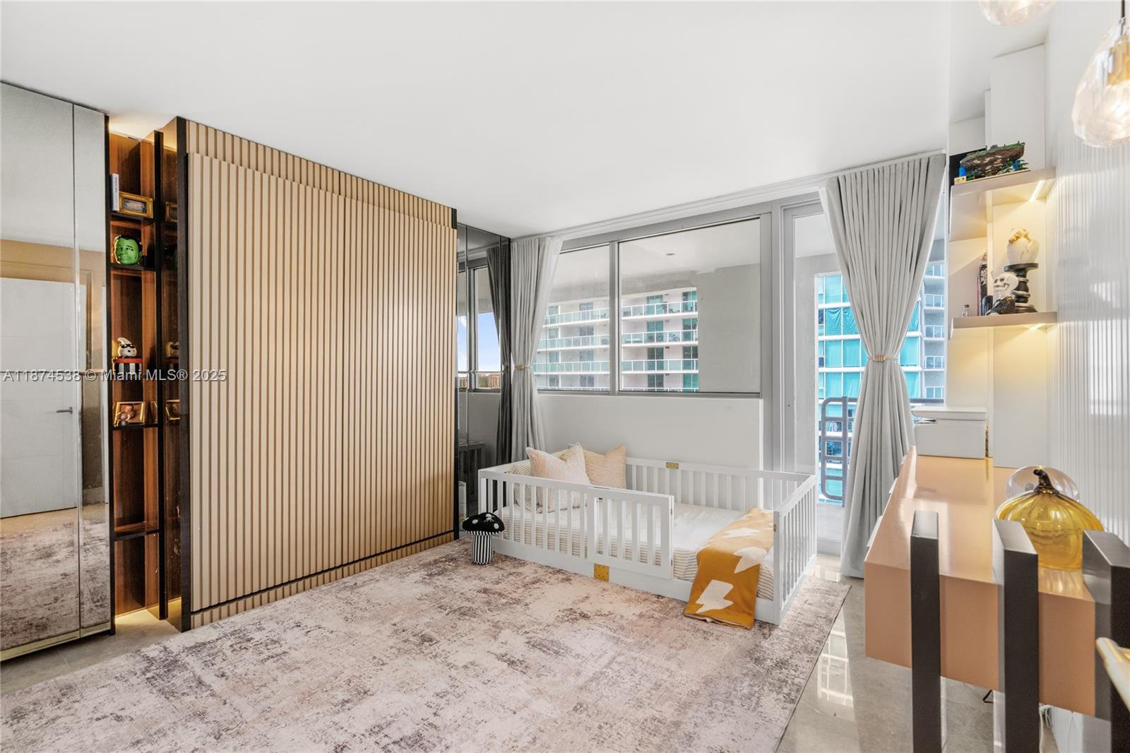 2025 Brickell Avenue, Unit 1705 Miami, FL 33129 - Photo 23 of 50 a bedroom with furniture and a window