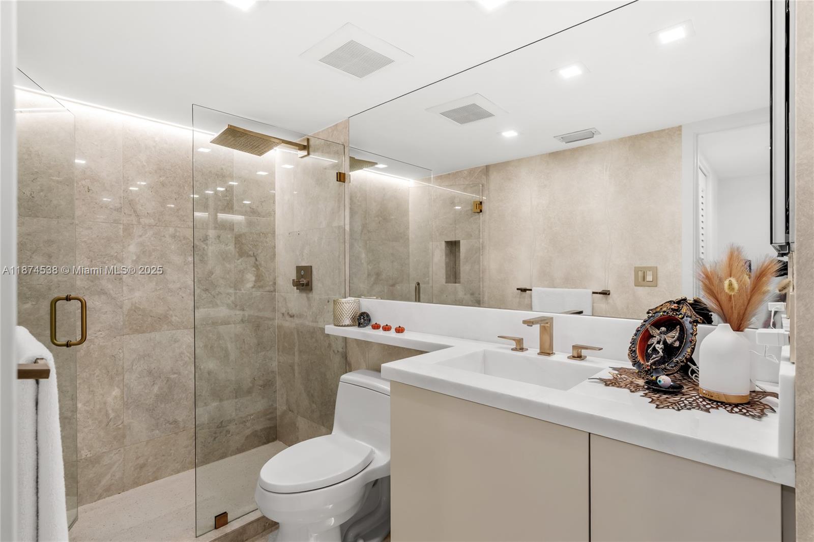 2025 Brickell Avenue, Unit 1705 Miami, FL 33129 - Photo 25 of 50 a bathroom with a sink a toilet and shower