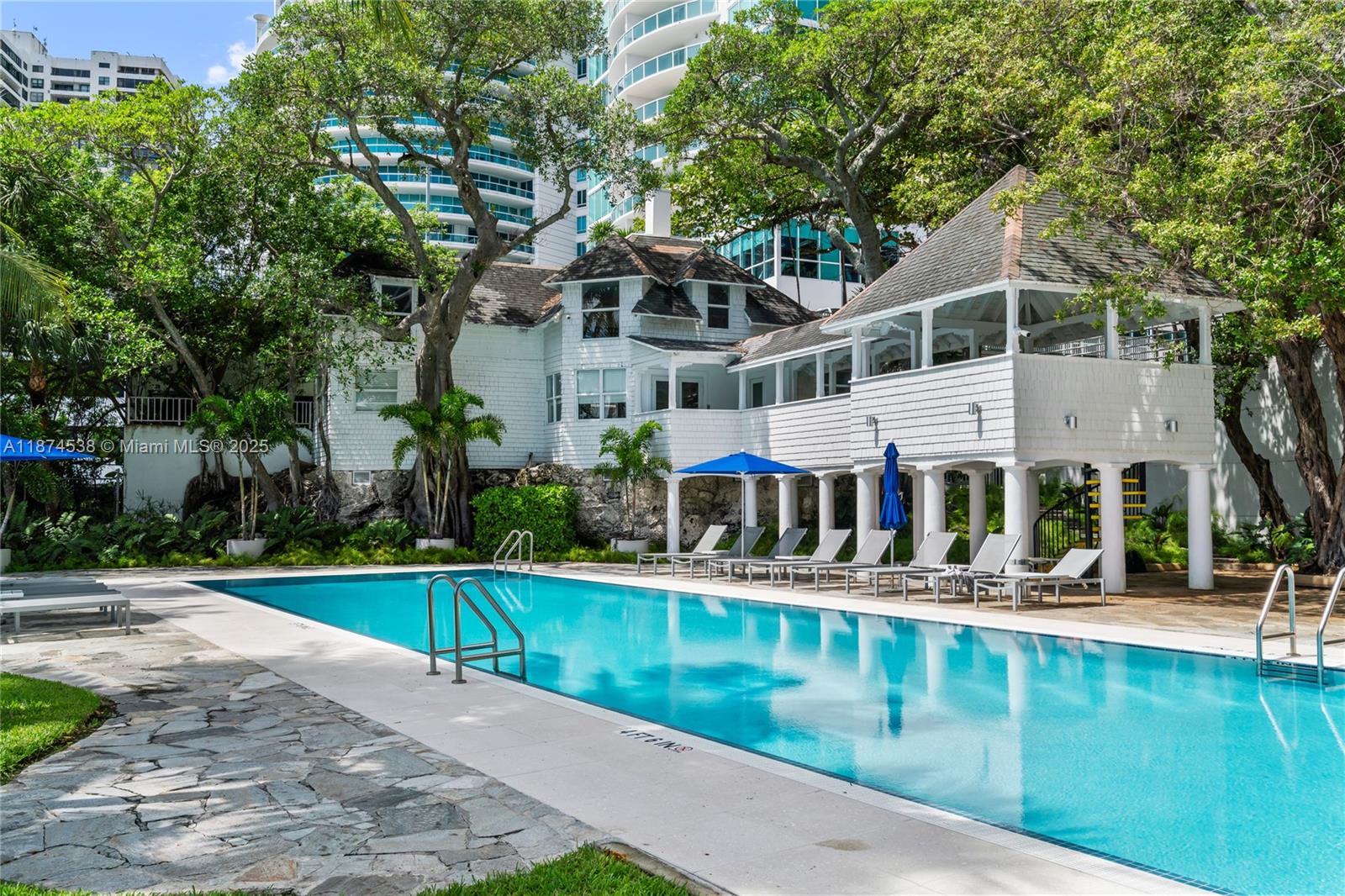2025 Brickell Avenue, Unit 1705 Miami, FL 33129 - Photo 45 of 50 front view of house with large windows and palm trees