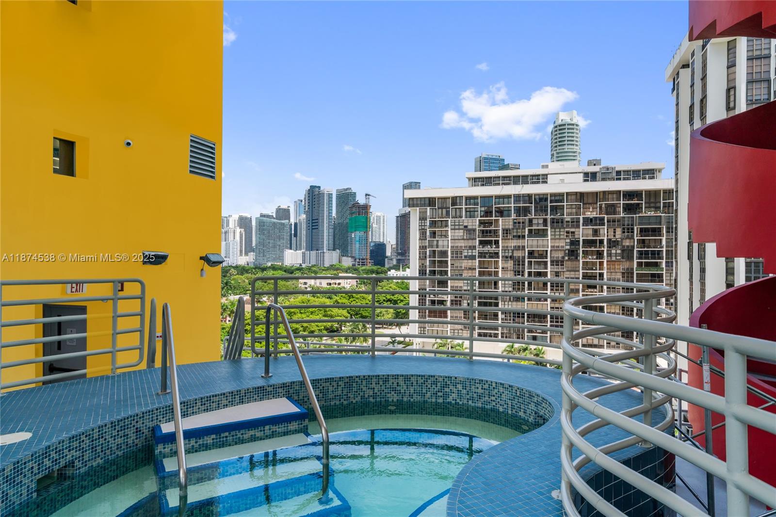 2025 Brickell Avenue, Unit 1705 Miami, FL 33129 - Photo 47 of 50 a view of a balcony with wooden chairs and iron fence