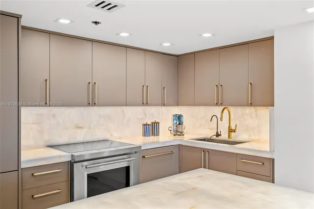 a kitchen with a sink cabinets and appliances