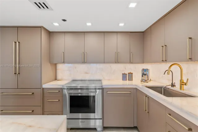 a kitchen with cabinets appliances and a sink