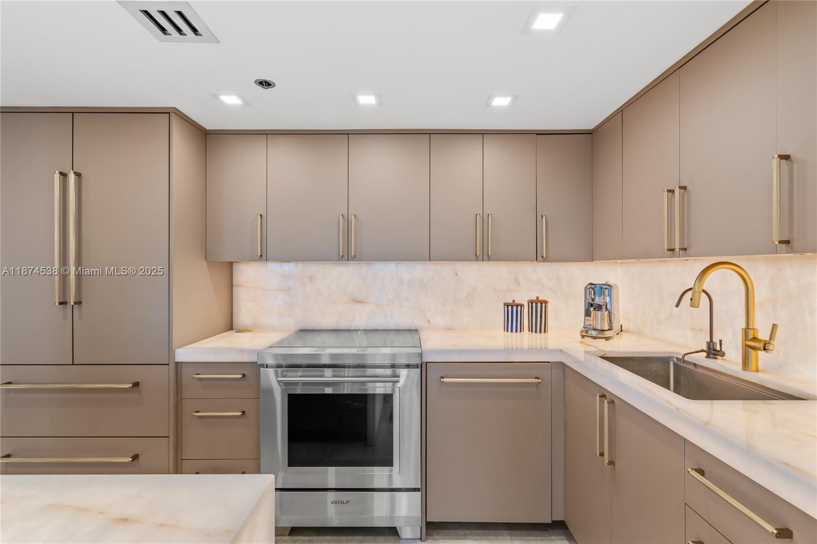 2025 Brickell Avenue, Unit 1705 Miami, FL 33129 - Photo 10 of 50 a kitchen with cabinets appliances and a sink