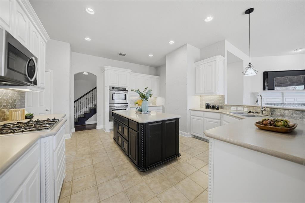 3475 Pilgrim Drive Frisco, TX 75034 - Photo 12 of 33 a kitchen with stainless steel appliances granite countertop a sink and a stove