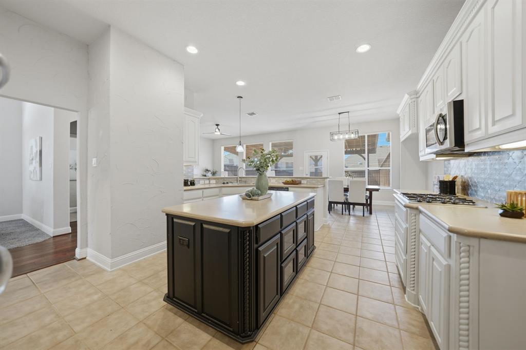 3475 Pilgrim Drive Frisco, TX 75034 - Photo 13 of 33 a large kitchen with stainless steel appliances granite countertop a sink and cabinets