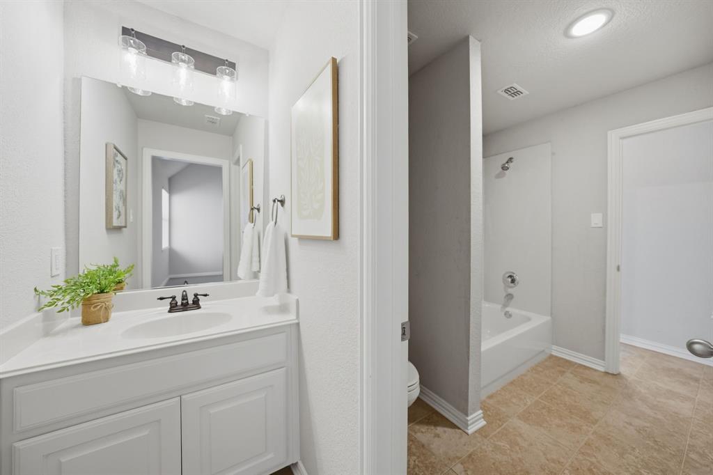 3475 Pilgrim Drive Frisco, TX 75034 - Photo 29 of 33 a bathroom with a sink and a mirror