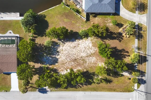 an aerial view of a house with a yard