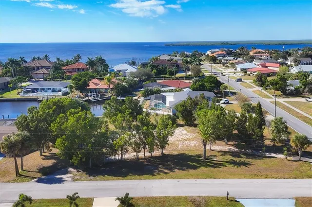 an aerial view of a house with a yard basket ball court and outdoor seating