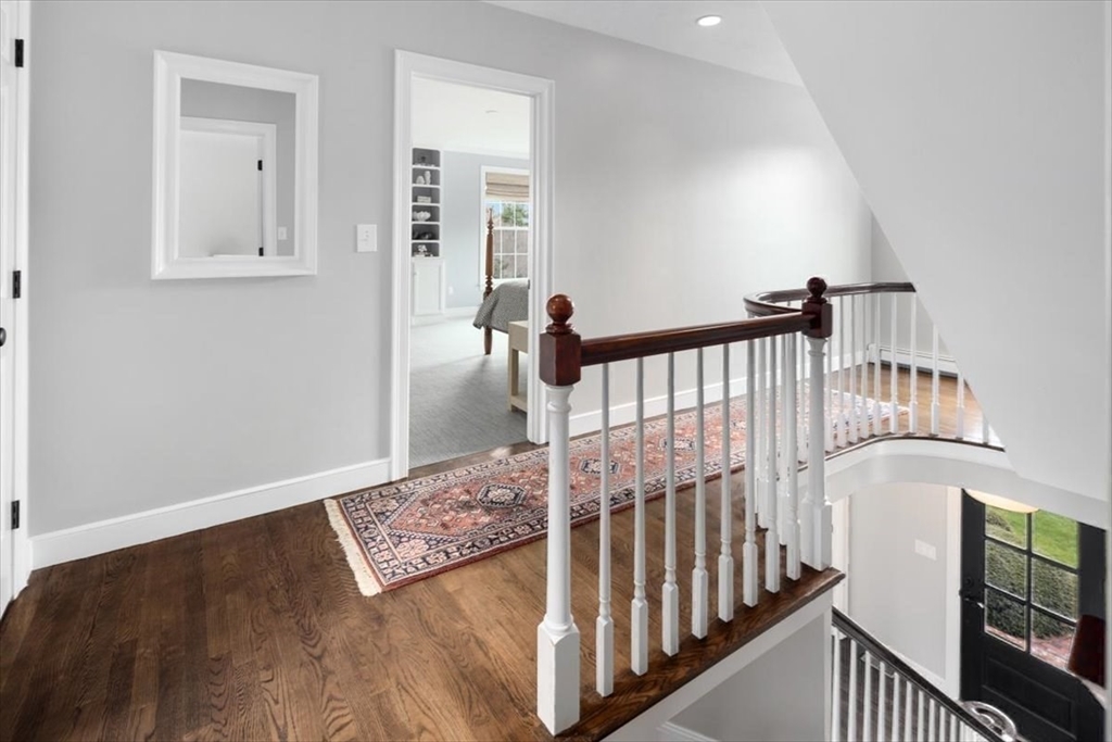 88 Jedediah's Path Marshfield, MA 02050 - Photo 19 of 41 a view of a hallway with wooden floor and stairs