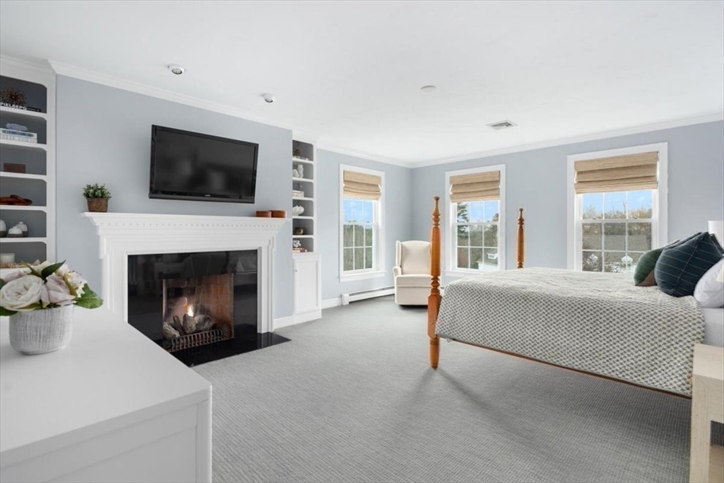 88 Jedediah's Path Marshfield, MA 02050 - Photo 20 of 41 a living room with furniture a flat screen tv and a fireplace