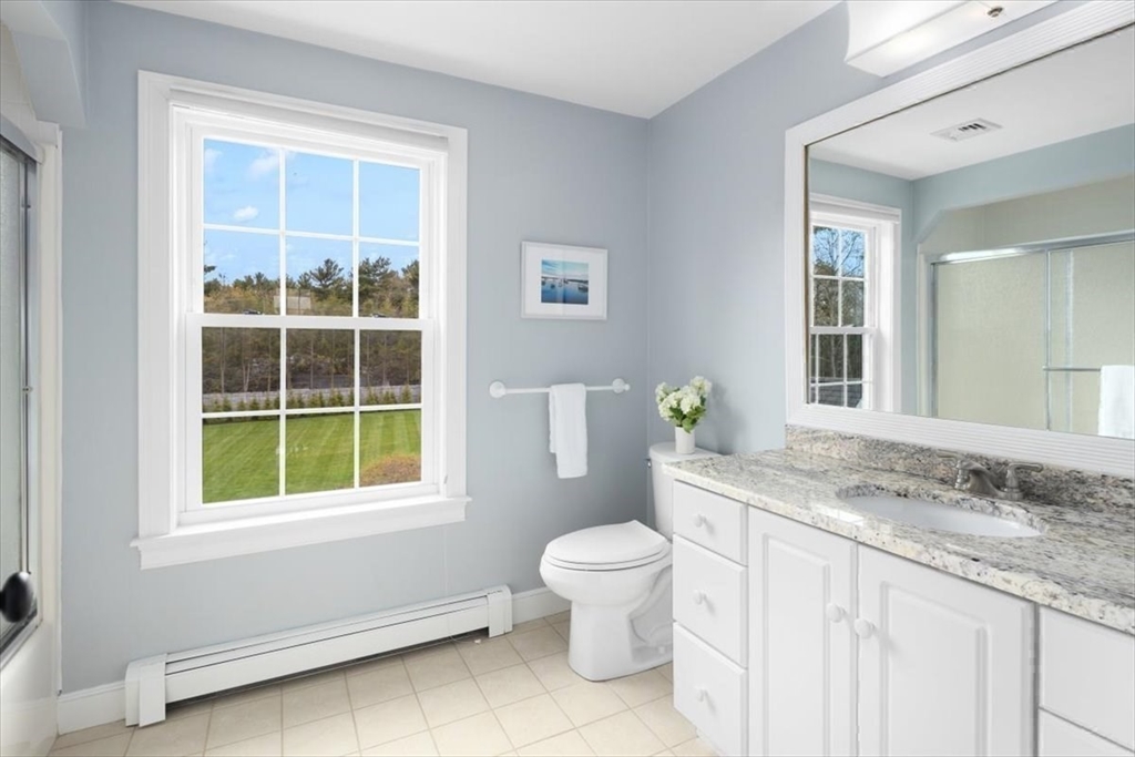 88 Jedediah's Path Marshfield, MA 02050 - Photo 28 of 41 a bathroom with a granite countertop toilet a sink a mirror and a window