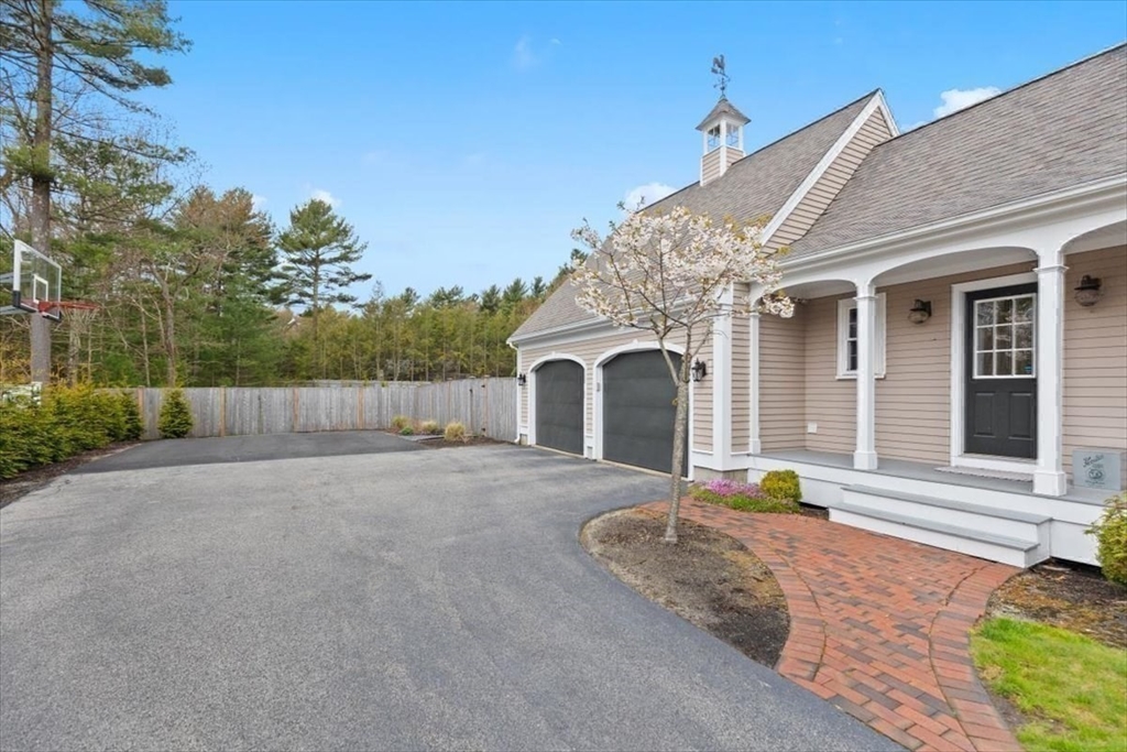 88 Jedediah's Path Marshfield, MA 02050 - Photo 37 of 41 a front view of a house with a yard and garage