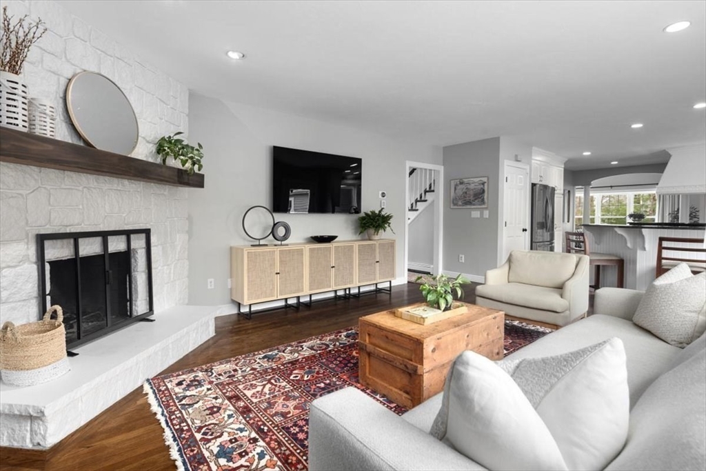88 Jedediah's Path Marshfield, MA 02050 - Photo 4 of 41 a living room with furniture a flat screen tv and a fireplace
