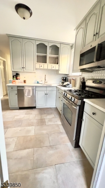 511 Hussa Street, Unit 2 Linden, NJ 07036 - Photo 2 of 13 a large kitchen with stainless steel appliances granite countertop a stove a sink dishwasher and a microwave oven with white cabinets
