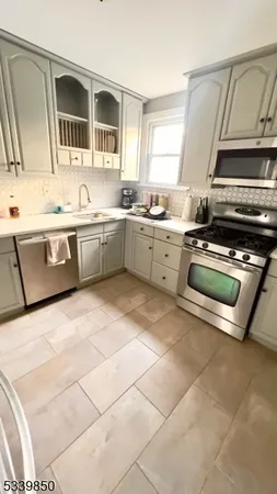 a kitchen with a stove a sink and a microwave