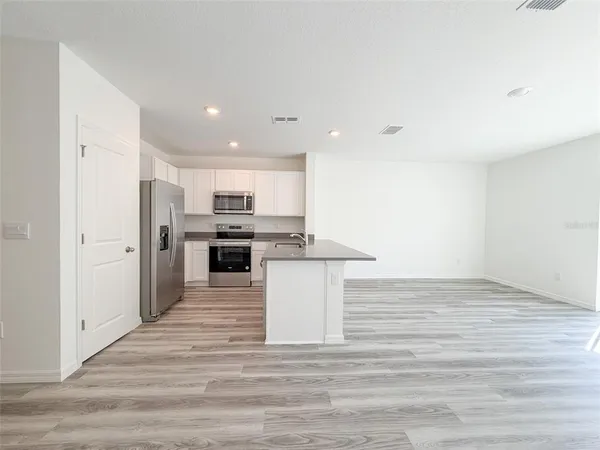 a view of kitchen with wooden floor