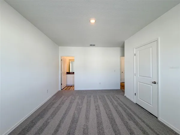 a view of a room with wooden floor and natural light