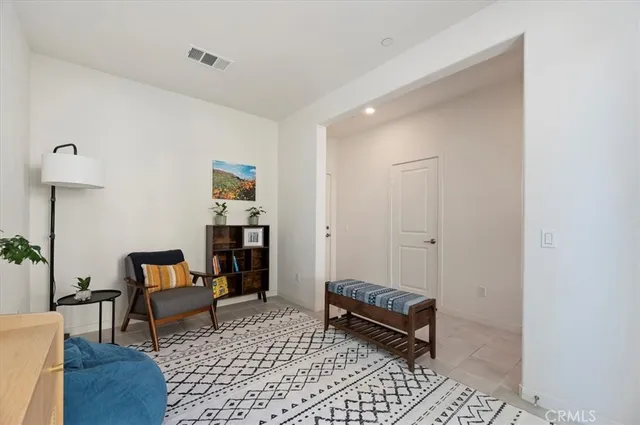 a bedroom with furniture and a rug