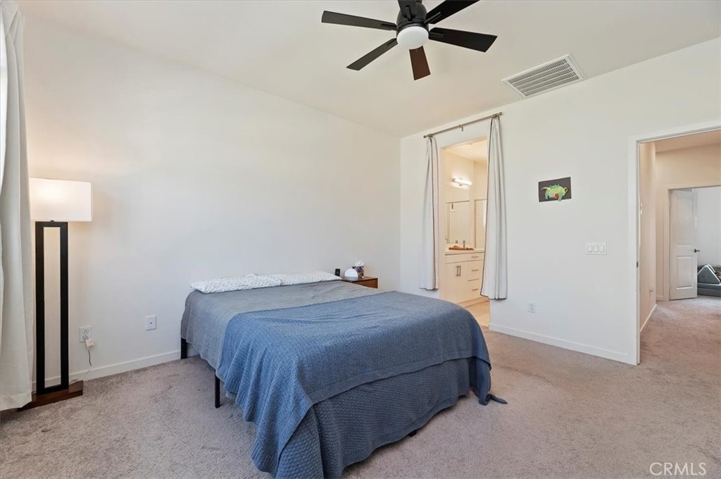 11012 Serenity Drive Rancho Cucamonga, CA 91730 - Photo 16 of 37 a bedroom with a bed and painting on the wall
