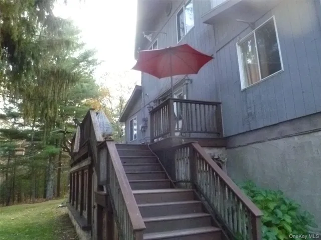a view of wooden house with a yard