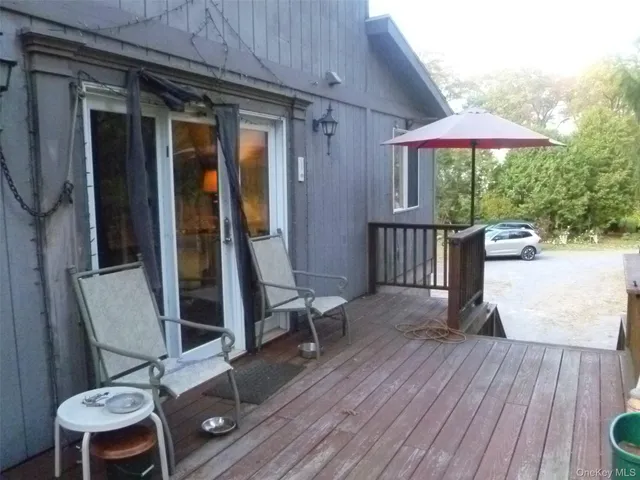 a view of balcony with wooden floor and furniture